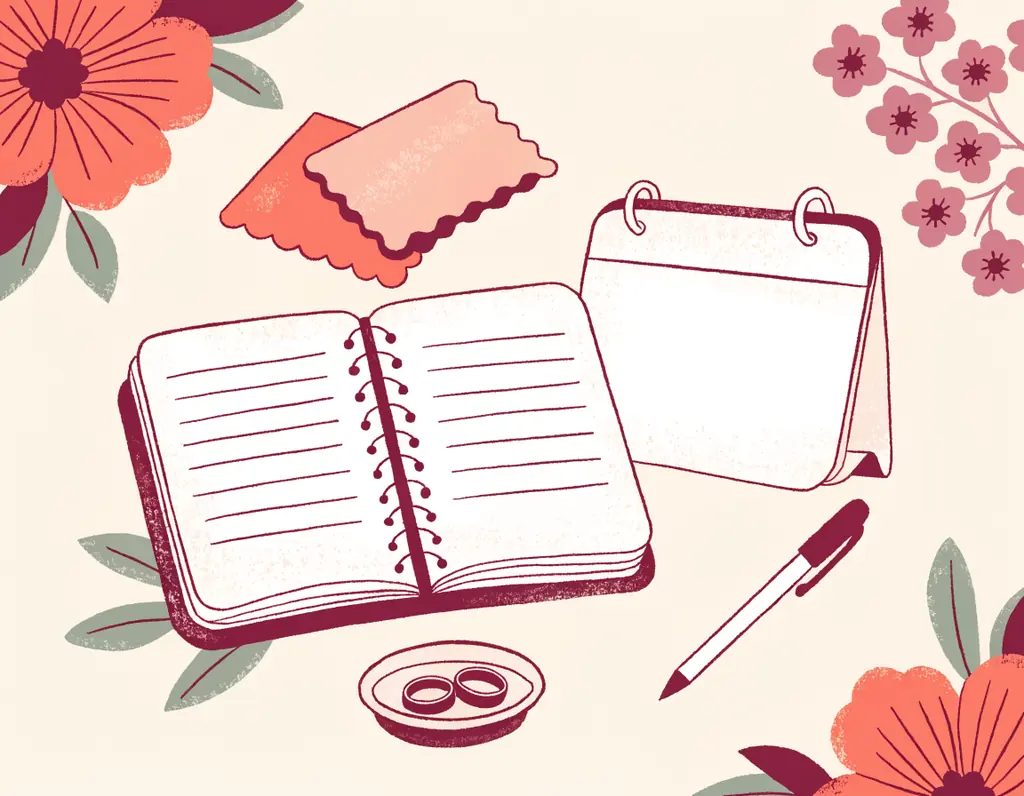 A wedding planner with blank lines, a calendar, fabric samples, two wedding rings in a small dish and a pen, surrounded by flowers